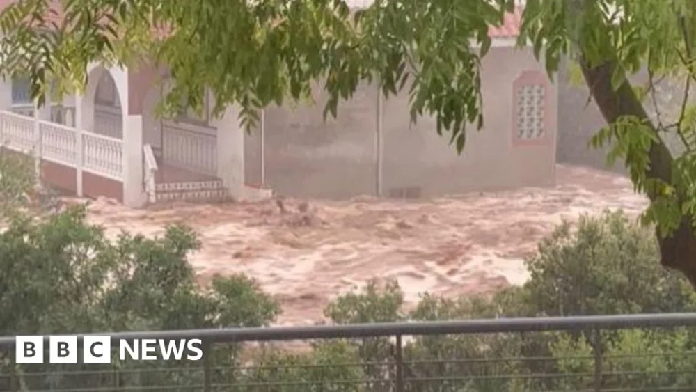 Floods trap people in cars in Spain’s Catalonia region.