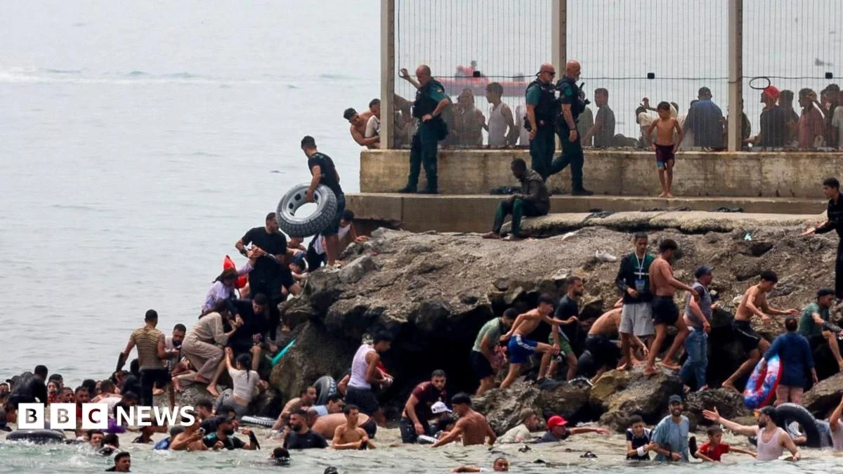 Hundreds of migrants swim from Morocco to Spanish enclave of Ceuta